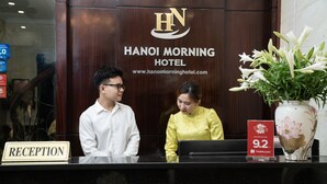 A reception desk at Hanoi Morning Hotel with a sign indicating the reception area. - Hanoi Morning Hotel (Hanoi)
