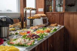 A buffet with various food items including salads, sandwiches, and fruit. - Hanoi Morning Hotel (Hanoi)