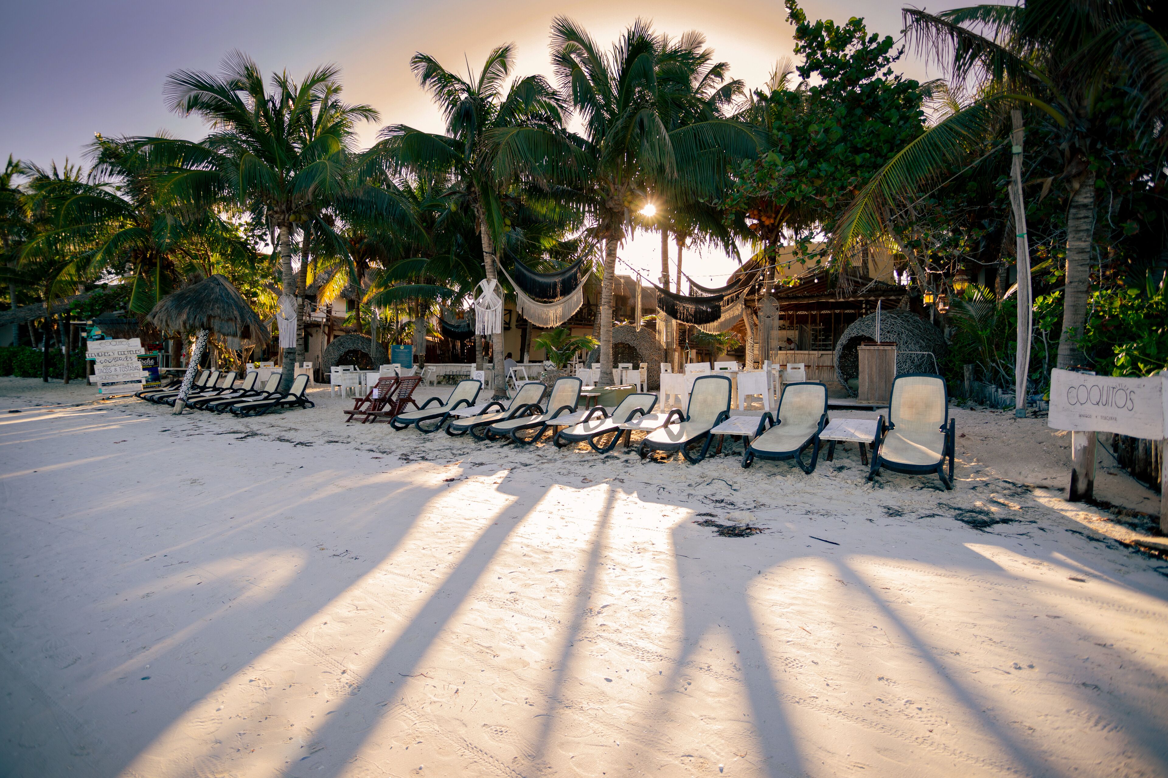 On the beach, white sand, sun loungers, beach towels