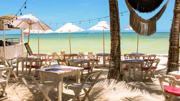 On the beach, white sand, sun-loungers, beach towels