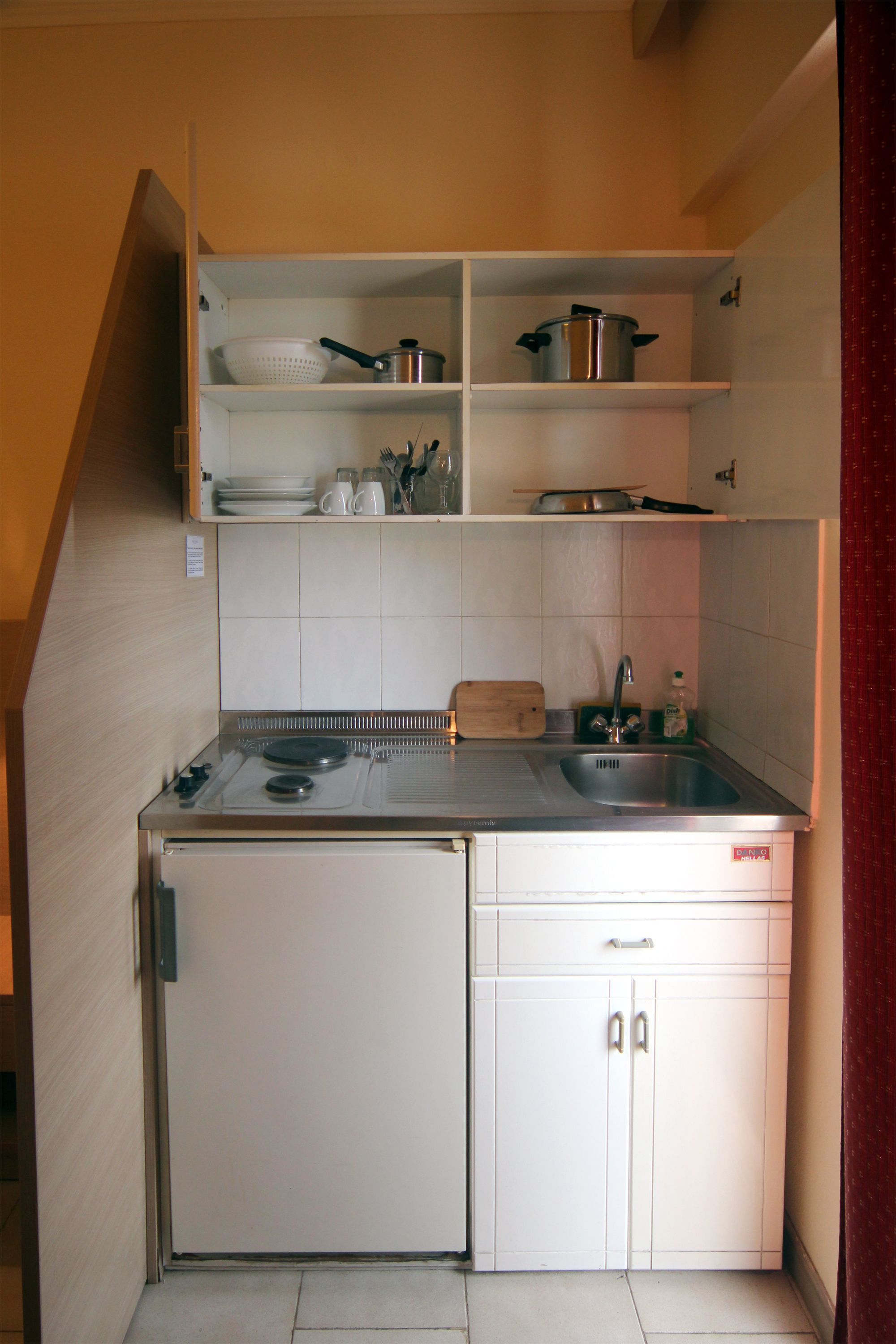 fridge, stovetop, electric kettle, cookware/dishes/utensils