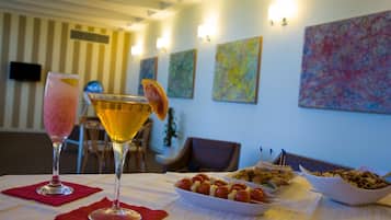 Een eettafel met een rijk beleid dessertplateau, een cocktailglas en een martini.