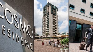 Een modern gebouw met een bord waarop 
