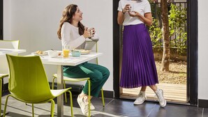 Two people dining indoors with a table, chairs, and a window with a view of greenery. - Aparthotel Adagio Access Paris Bastille (Paris)