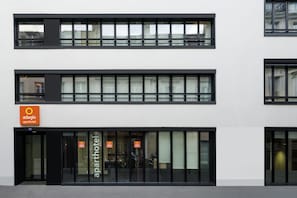 A modern building with a sign for 'adagio aparthotel'.