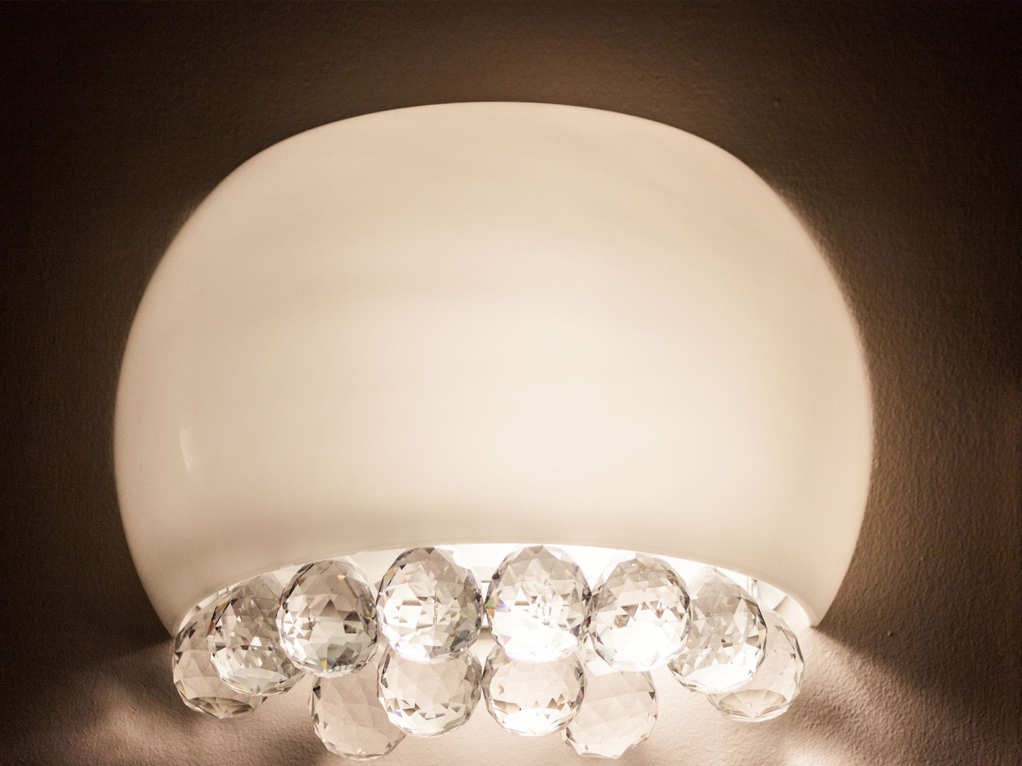 A row of clear, faceted gemstones on a reflective surface.