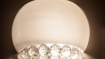 A row of clear, faceted gemstones on a reflective surface.