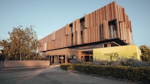 A modern building with a wooden facade and a sign reading "mod05."