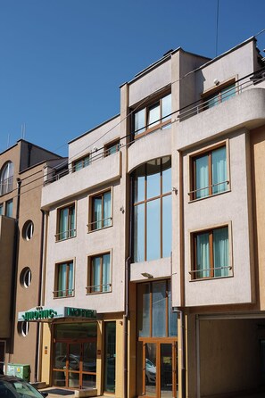 A hotel with a modern facade, large windows, and a visible entrance. - Dionis Hotel (Varna)