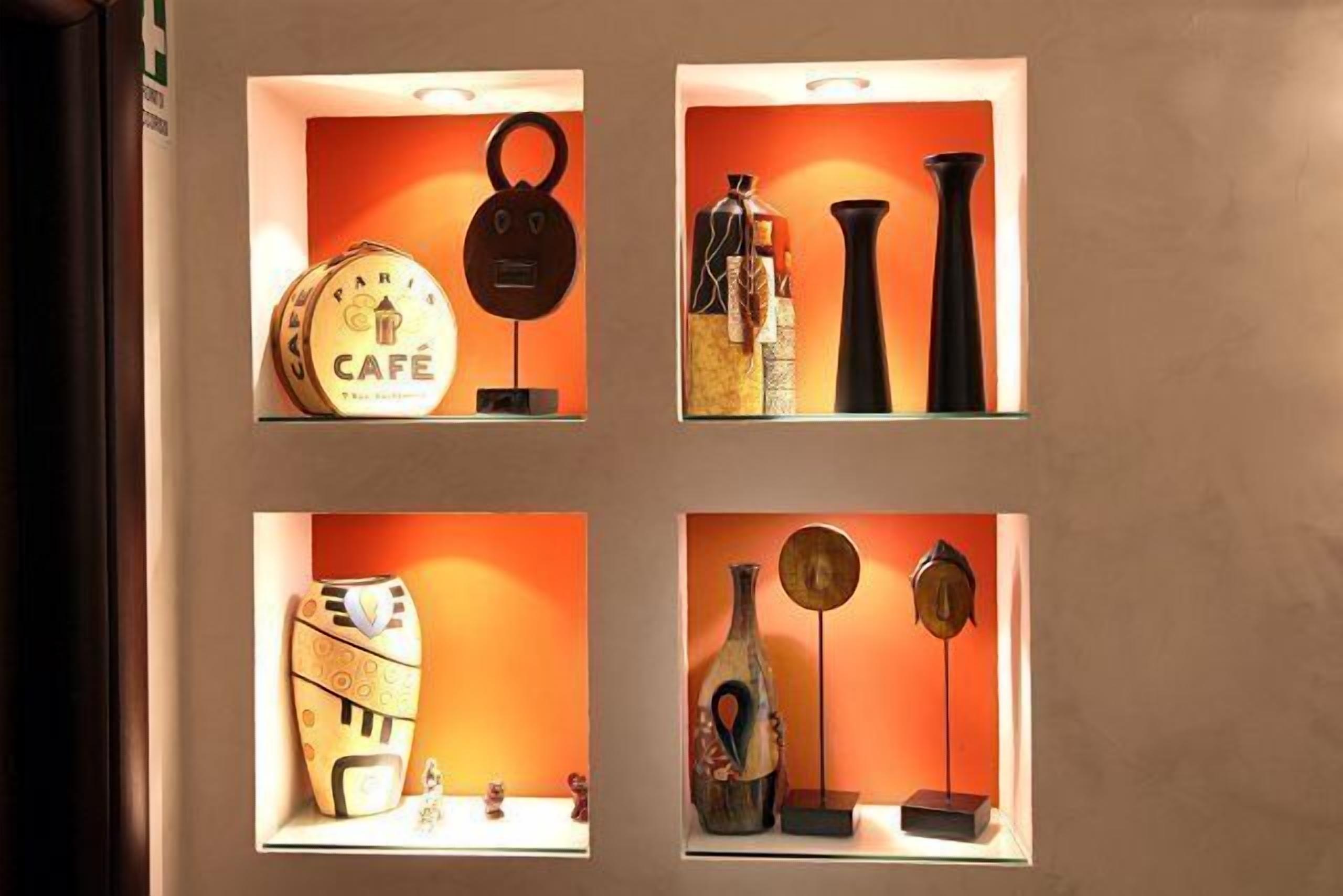 Four wall-mounted display cases with various decorative items.