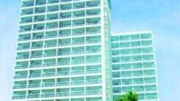 A high-rise hotel building with multiple floors and balconies.