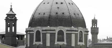 A historic building with a large dome and two bell towers.
