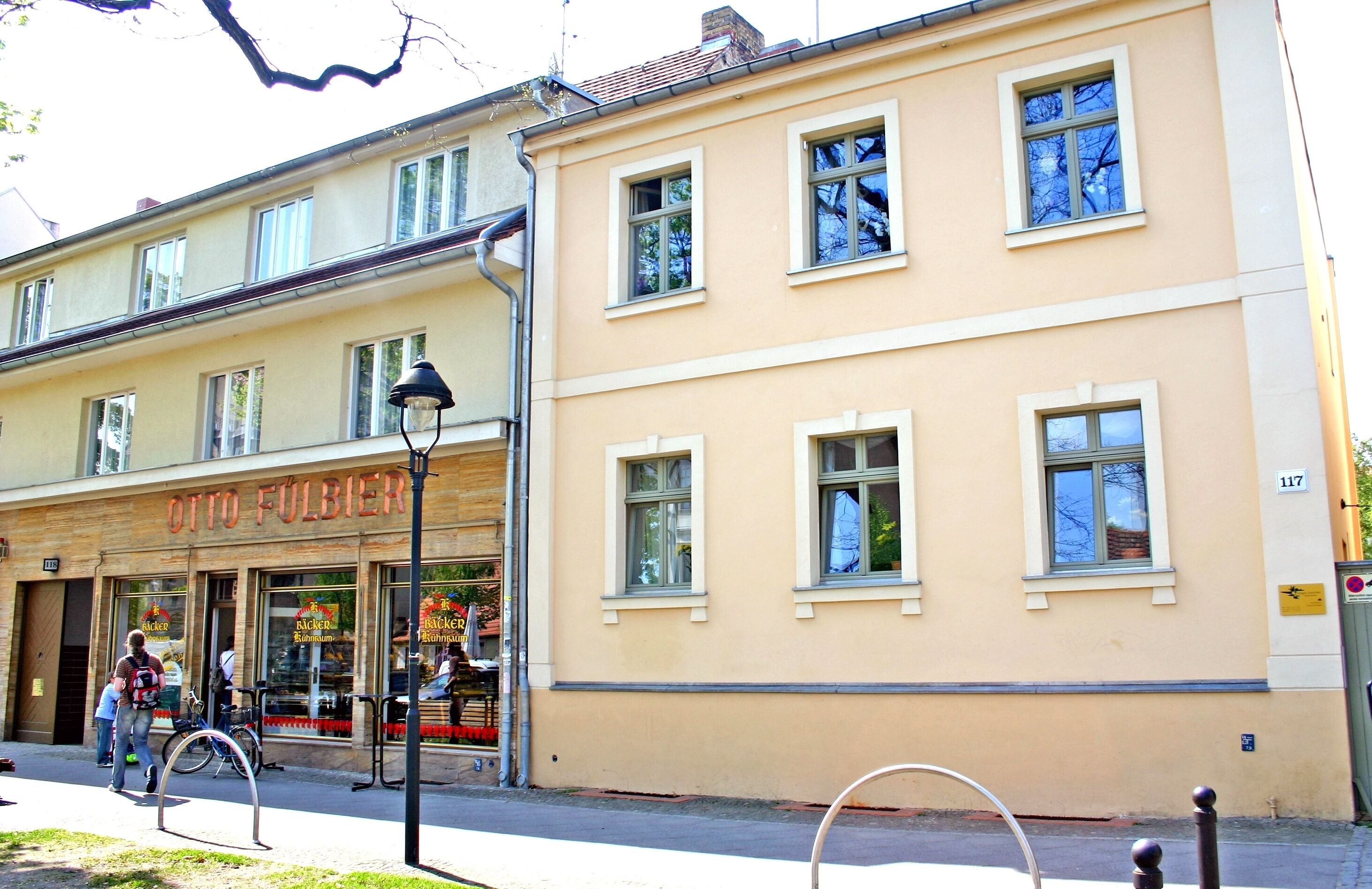 A building with a storefront labeled "OTTO FULBIER" and multiple windows.