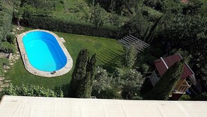 A swimming pool surrounded by a well-maintained lawn and trees. - Margarita (Varna)