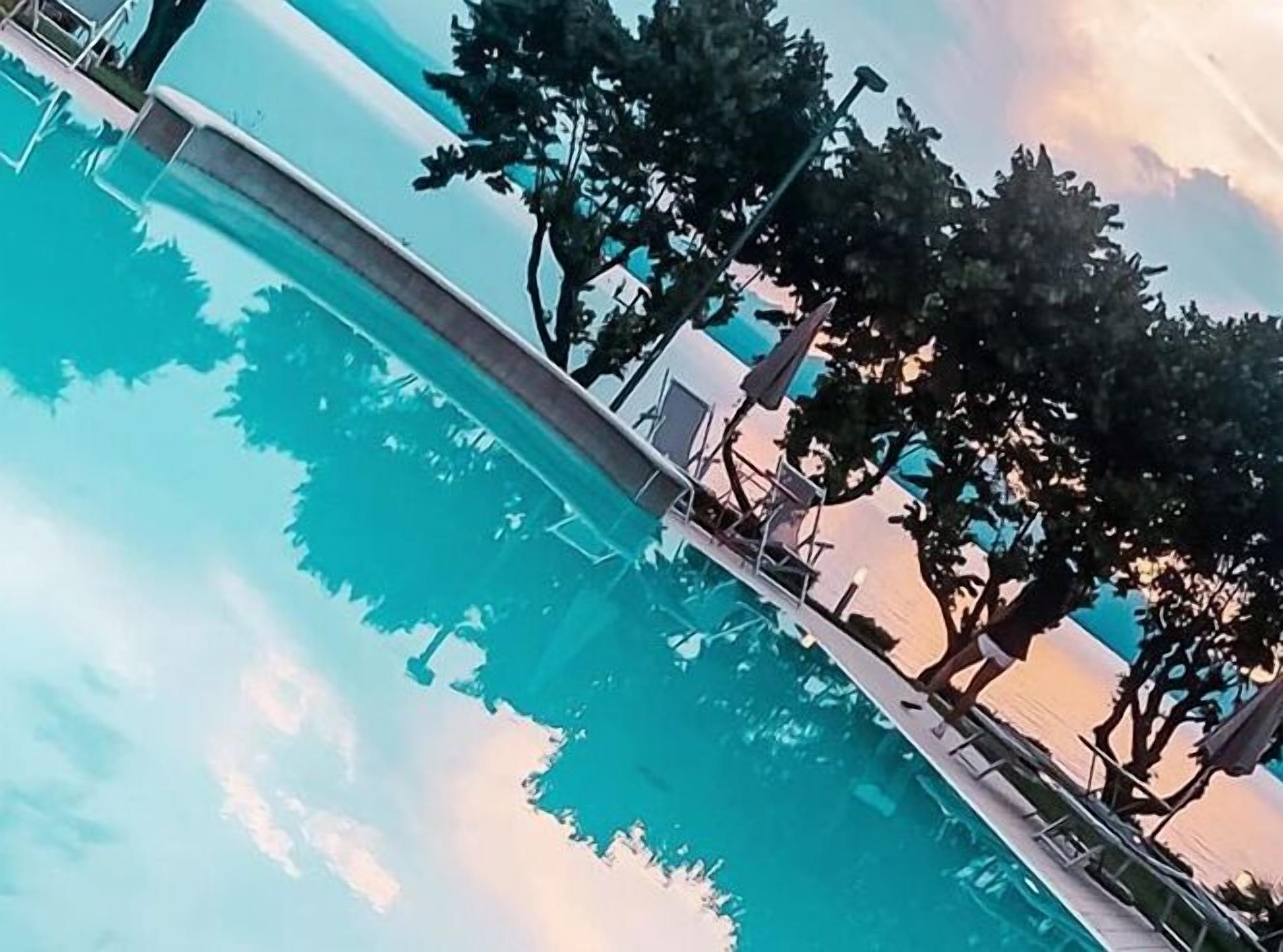 outdoor pool, open 8:00 am to 8:00 pm, pool umbrellas, pool loungers