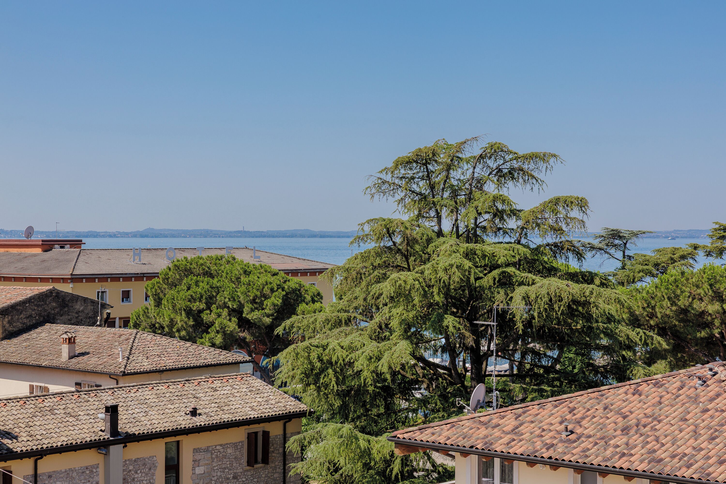 A coastal town with traditional buildings, a clear sky, and a view of the sea.