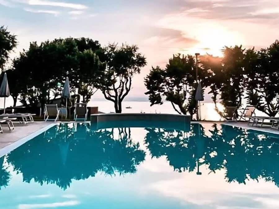 Outdoor pool, open 8:00 AM to 8:00 PM, pool umbrellas, sun loungers