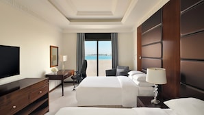 A hotel room with a large bed, a desk, a chair, a TV, and a view of the sea. - InterContinental Jeddah by IHG (Jeddah)