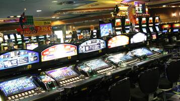 A casino with multiple slot machines and gaming tables.