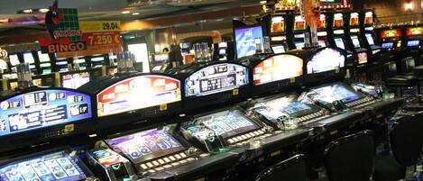 A casino with multiple slot machines and gaming tables.