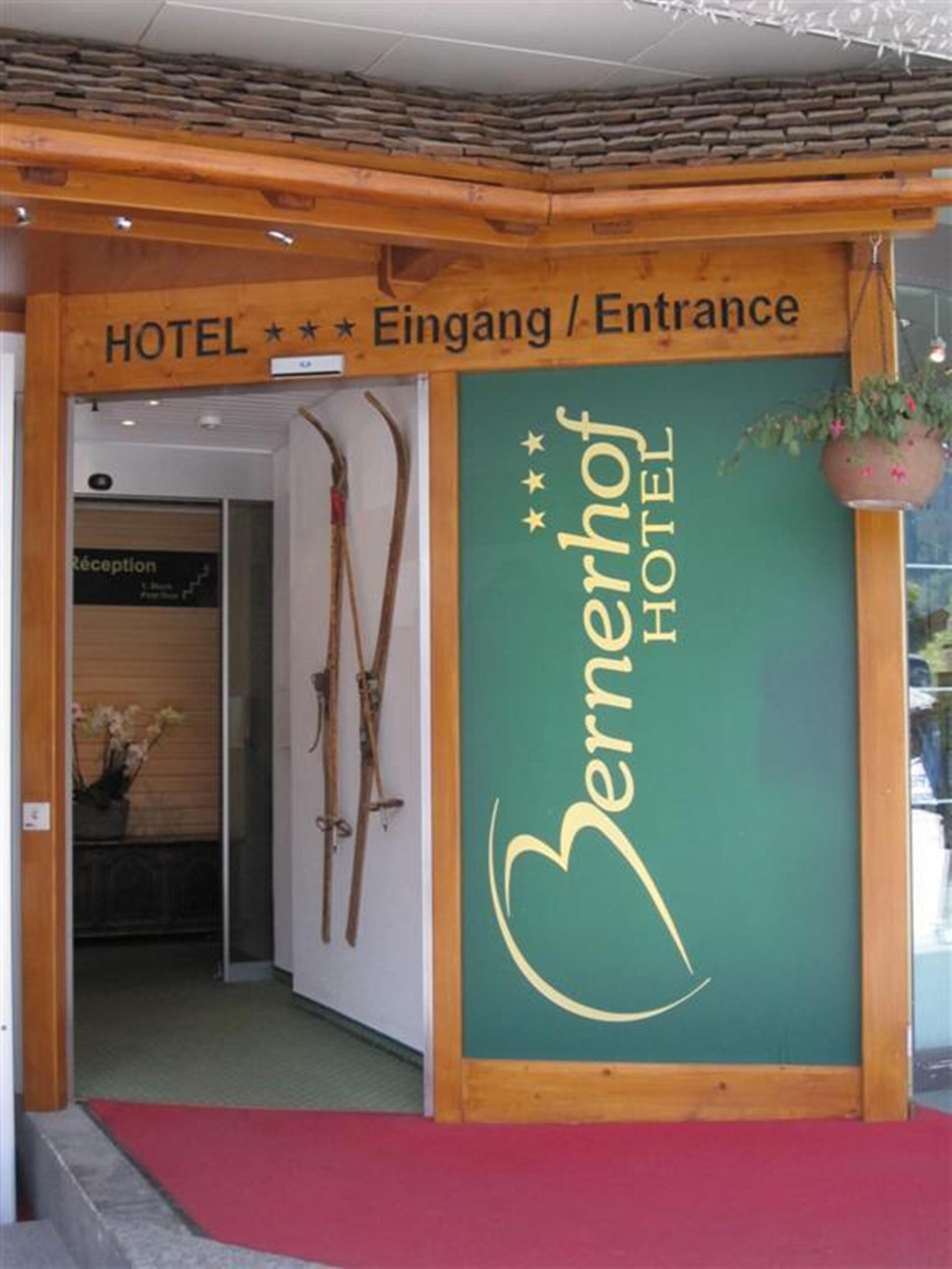 The entrance of the Bernerhof Hotel with a sign indicating the reception area.