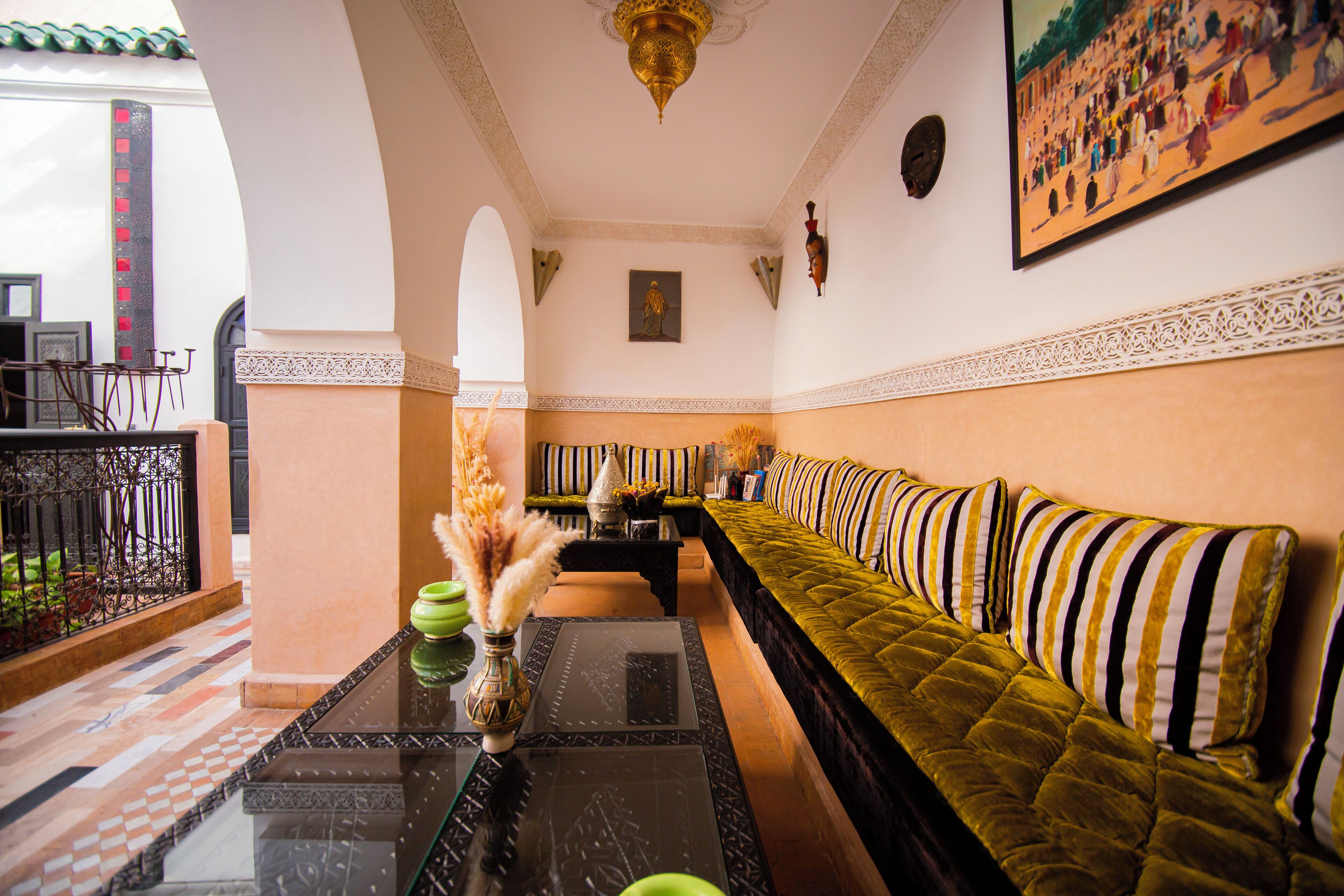 A room with a sofa, a table, and a decorative vase.