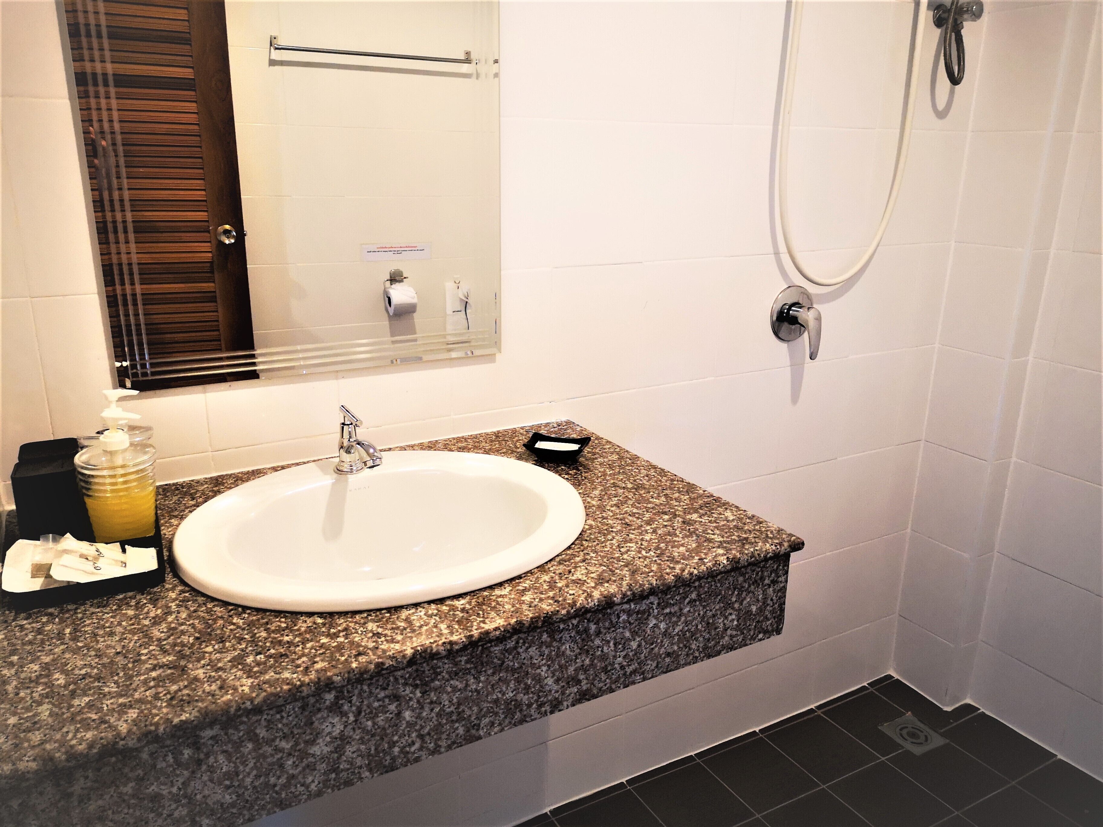 shower, hair dryer, slippers, towels