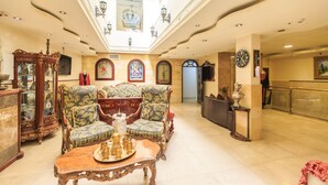 A spacious lobby with ornate furniture, a high ceiling, and a grand chandelier. - Hashimi Hotel (Jerusalem)