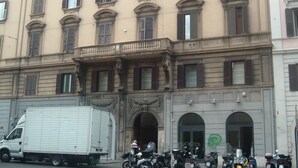 A multi-story building with a classic architectural style, featuring arched windows and a balcony. - San Giovanni in Laterano (Rome)