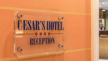 A reception sign for Caesar's Hotel.