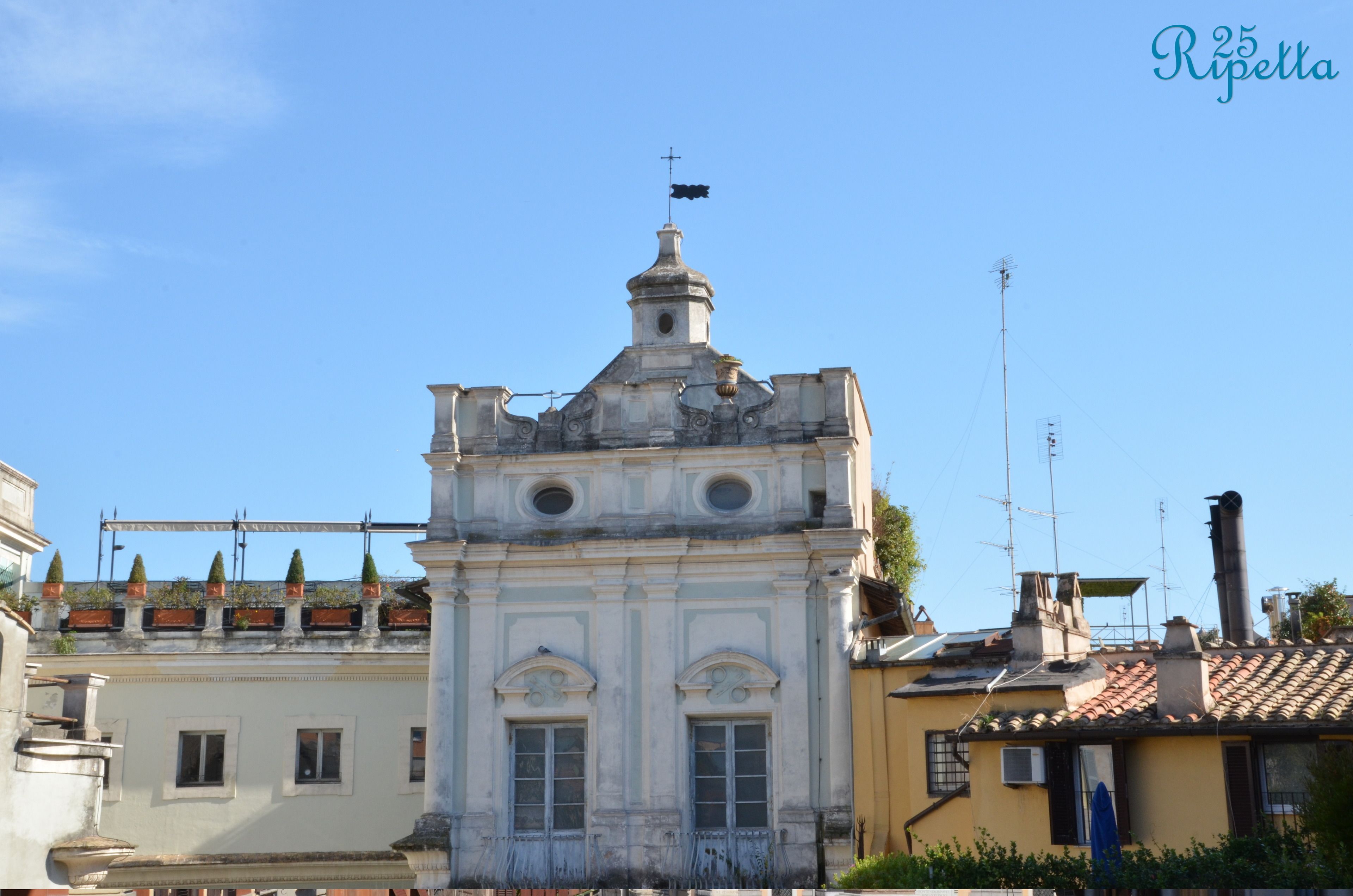 A historic building with a central dome and a bell tower.