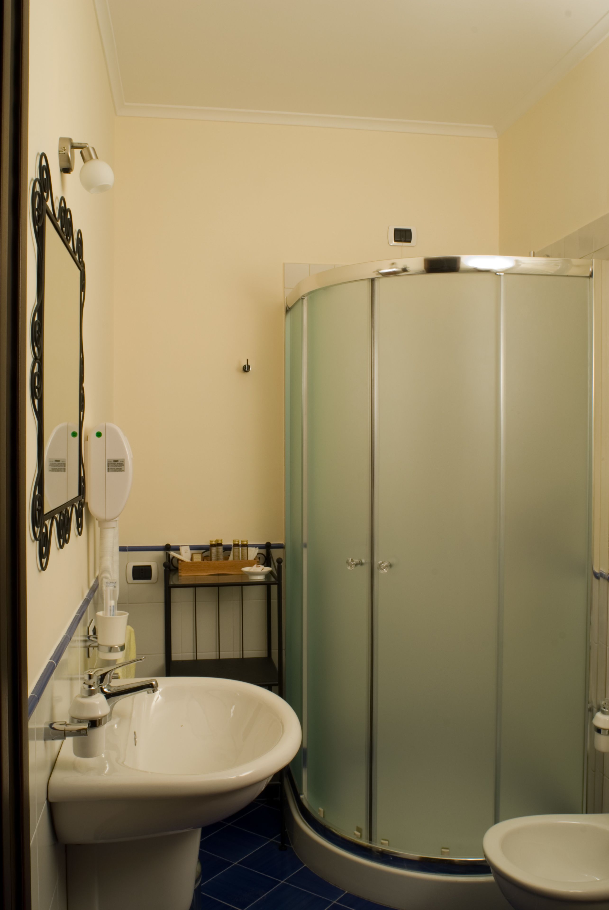 A bathroom with a sink, toilet, and a glass-enclosed shower.
