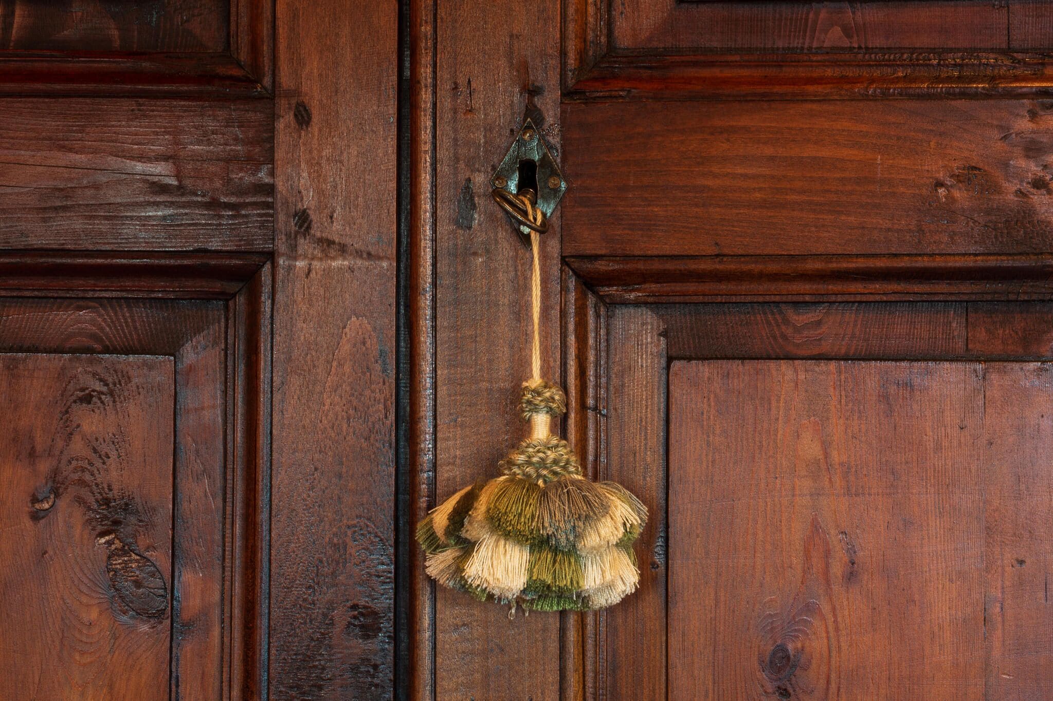 A wooden door with a brass doorknob.