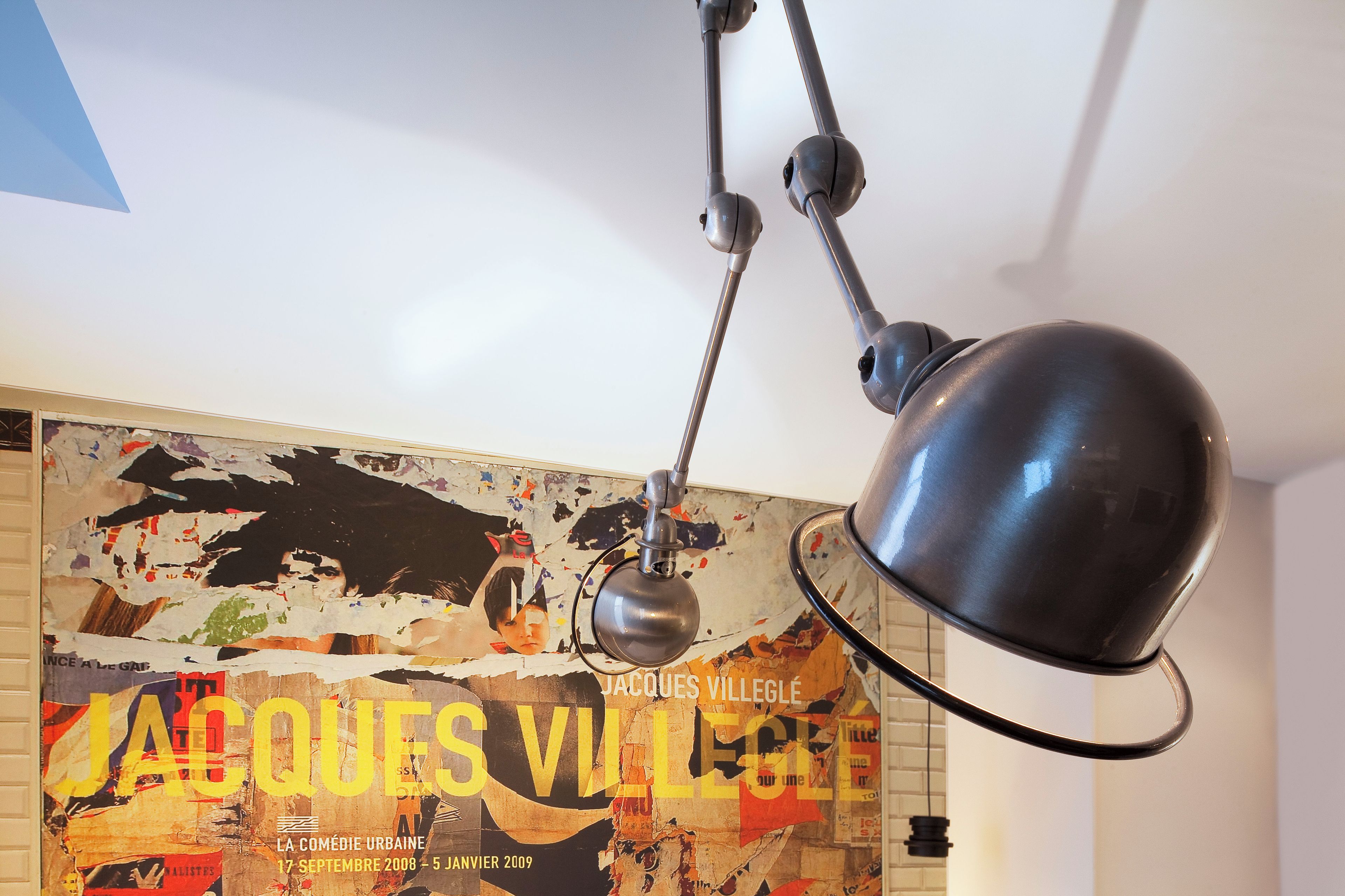 A ceiling-mounted lamp with a spherical shade and a pendant light with a curved arm.