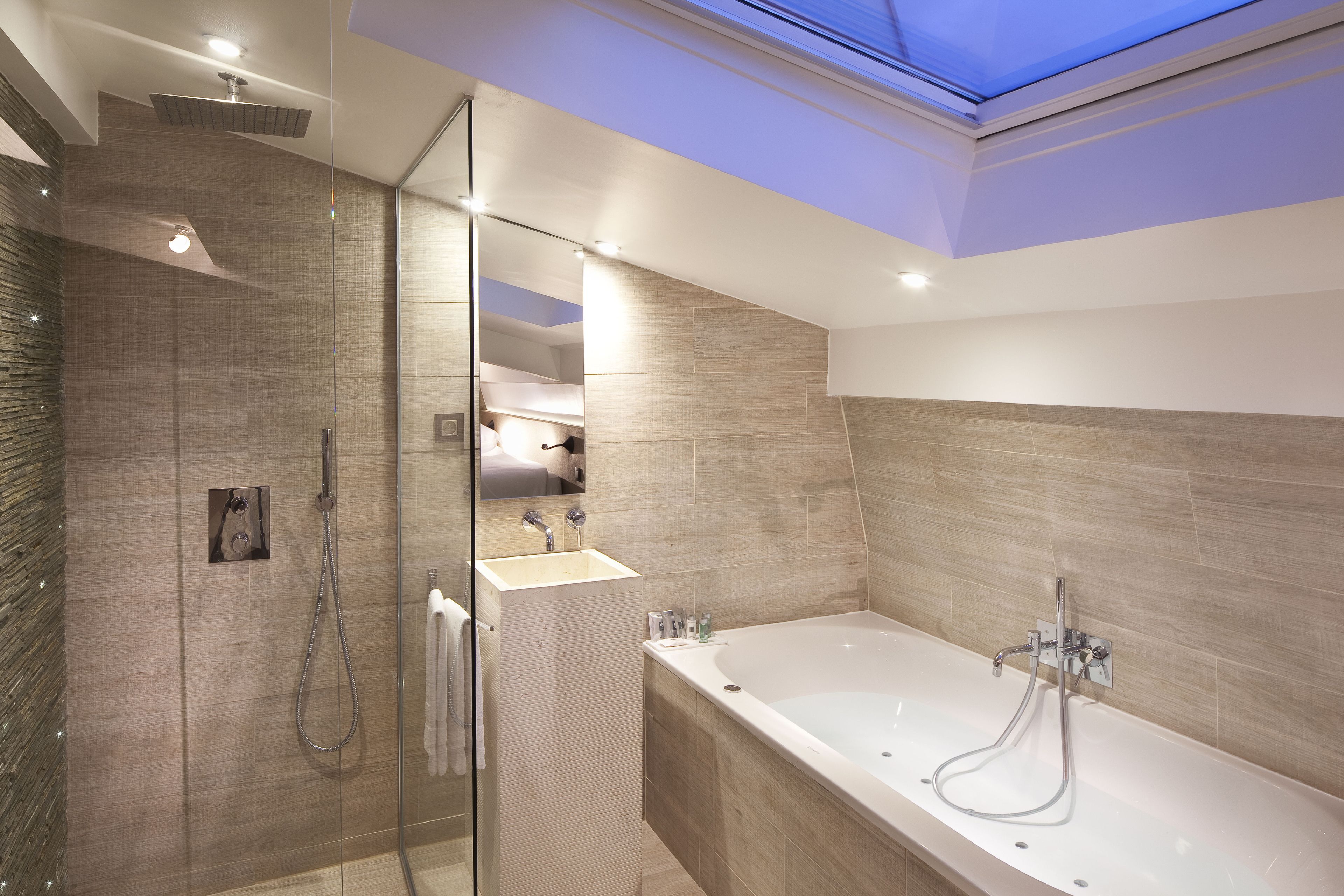 deluxe room | bathroom | rainfall showerhead, free toiletries, hair dryer, towels
