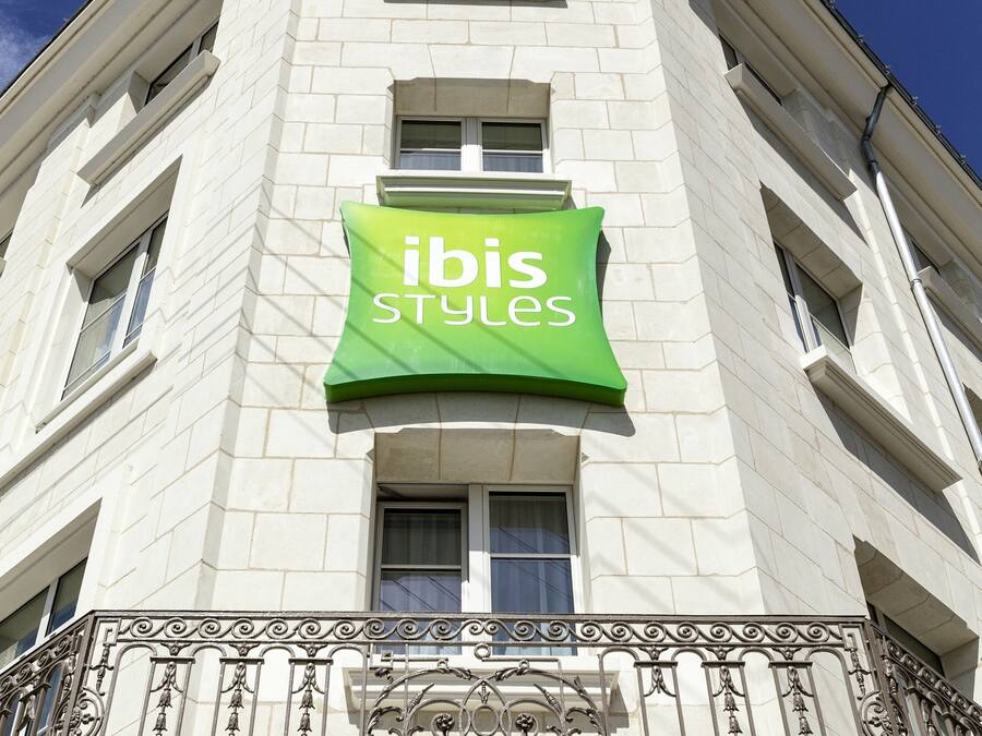 Un edificio con una insegna che riporta 'ibis Styles' sulla facciata.