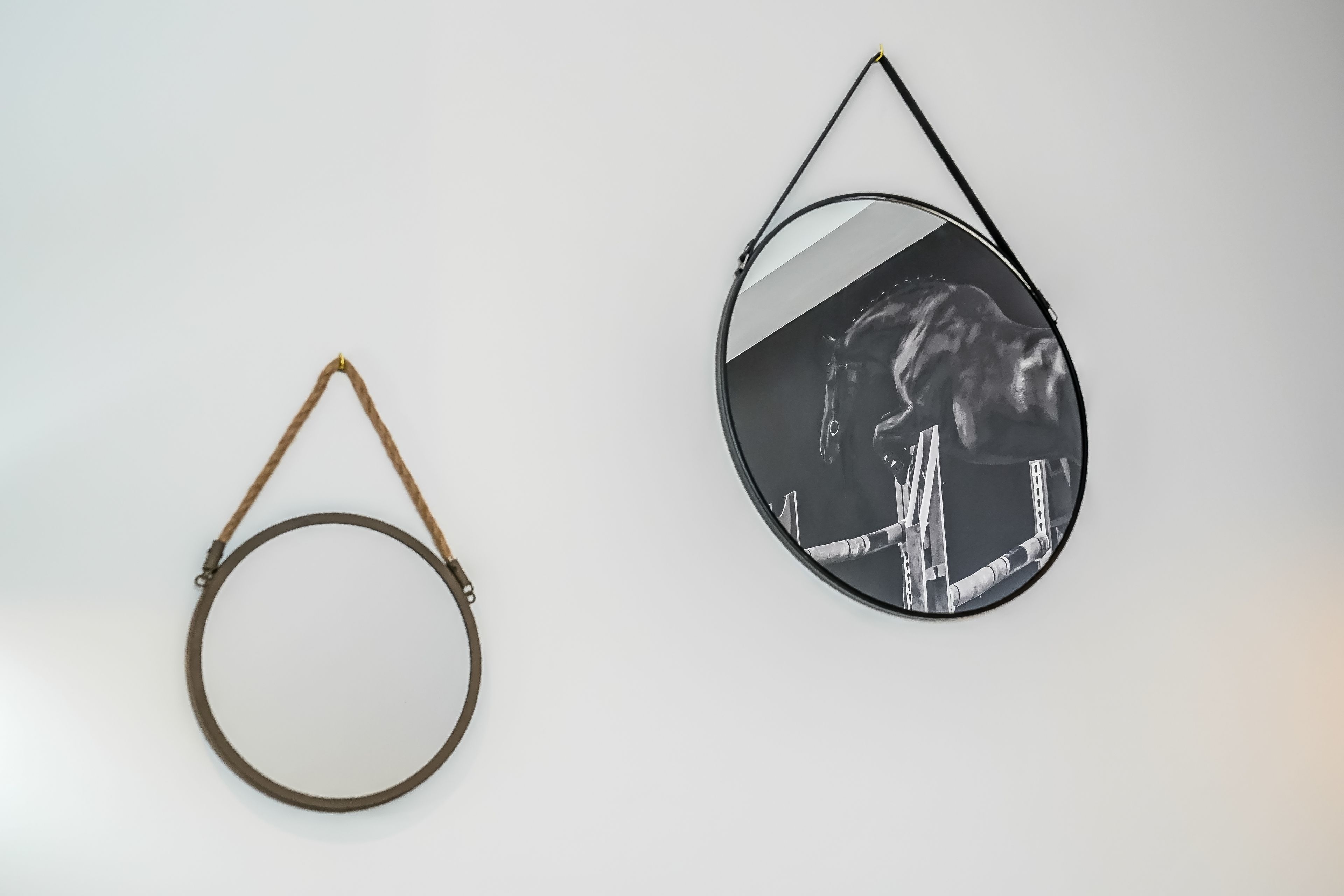 Two circular wall decorations, one plain and one with a reflective surface.