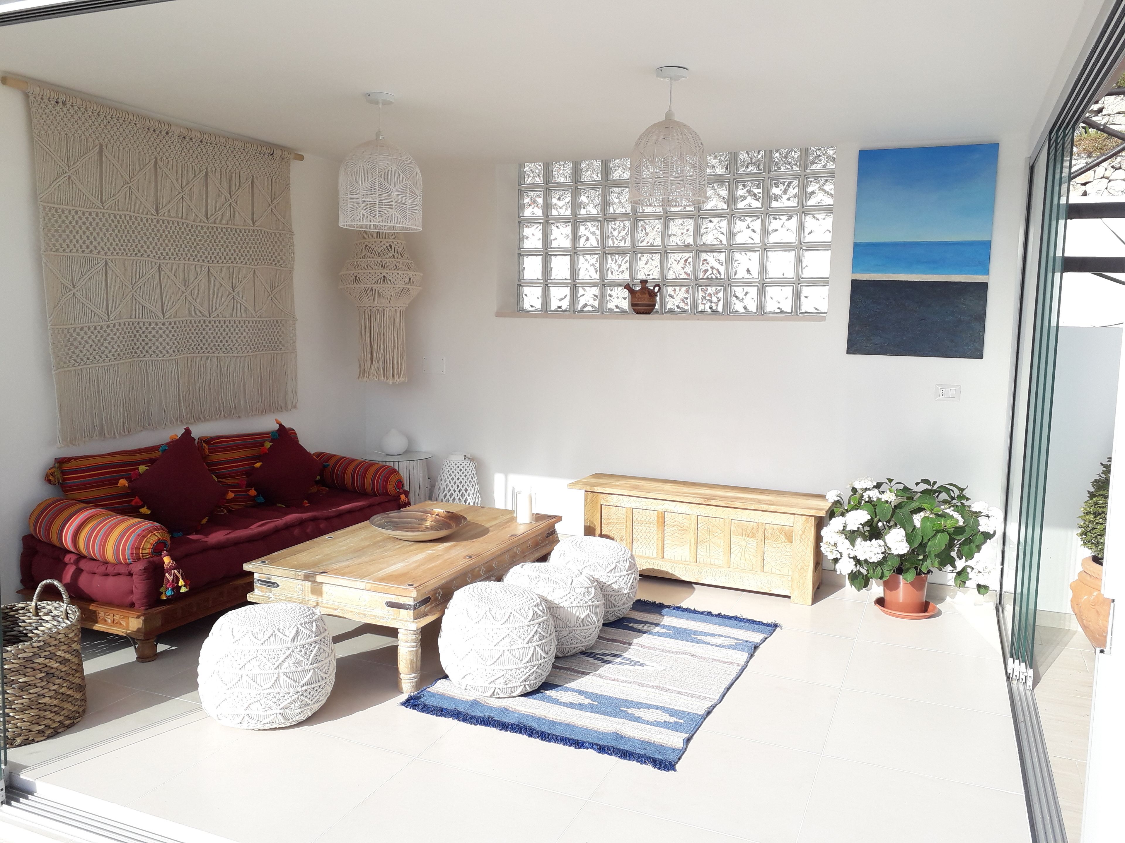 A living room with a sofa, coffee table, and decorative items.
