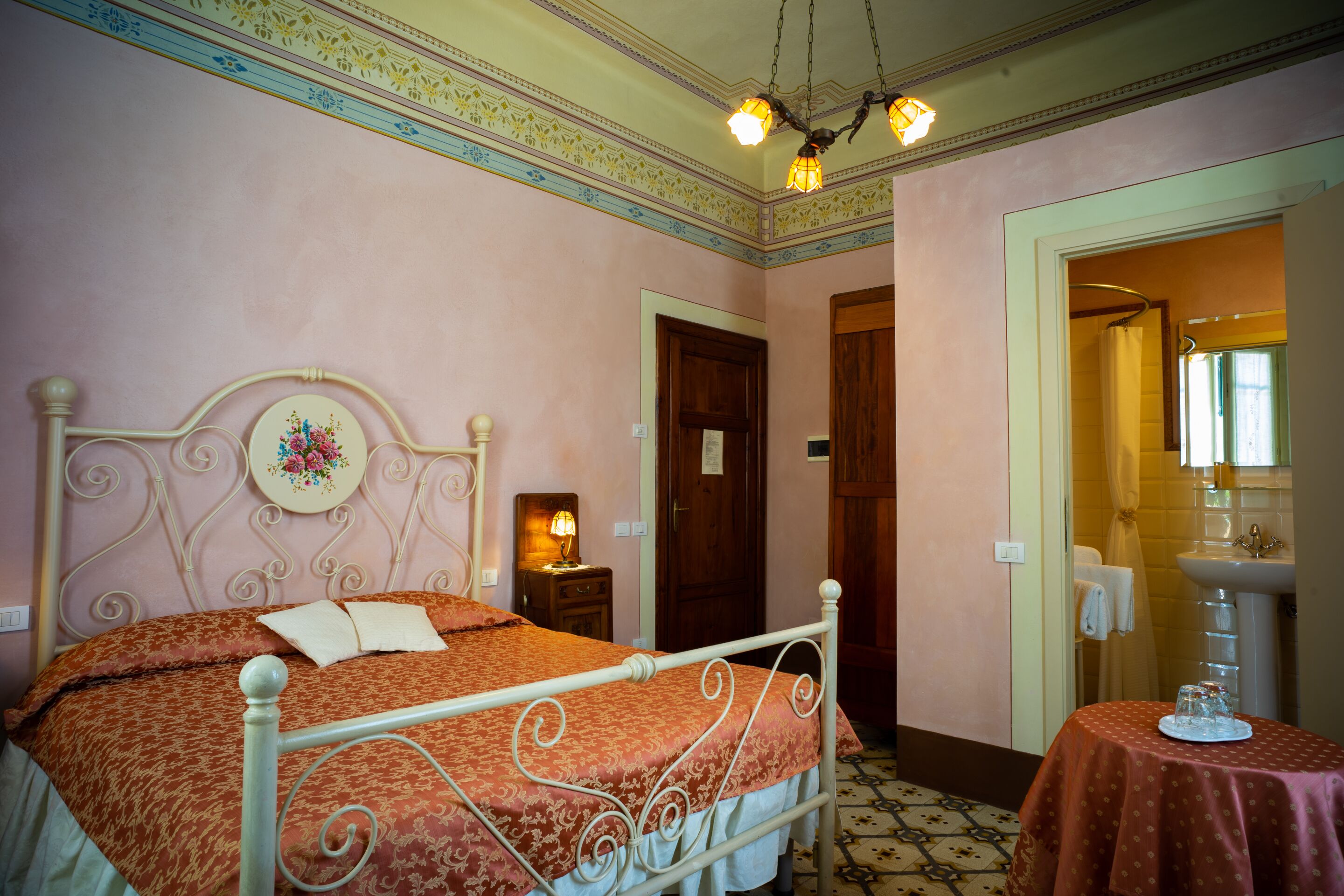 A bedroom with a bed, bedside table, and a small table with a tray.