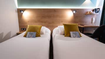 Premium bedding, desk, laptop workspace, blackout drapes