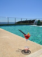 Outdoor pool, a rooftop pool, pool umbrellas, sun loungers