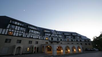 A large building with multiple windows and a courtyard.
