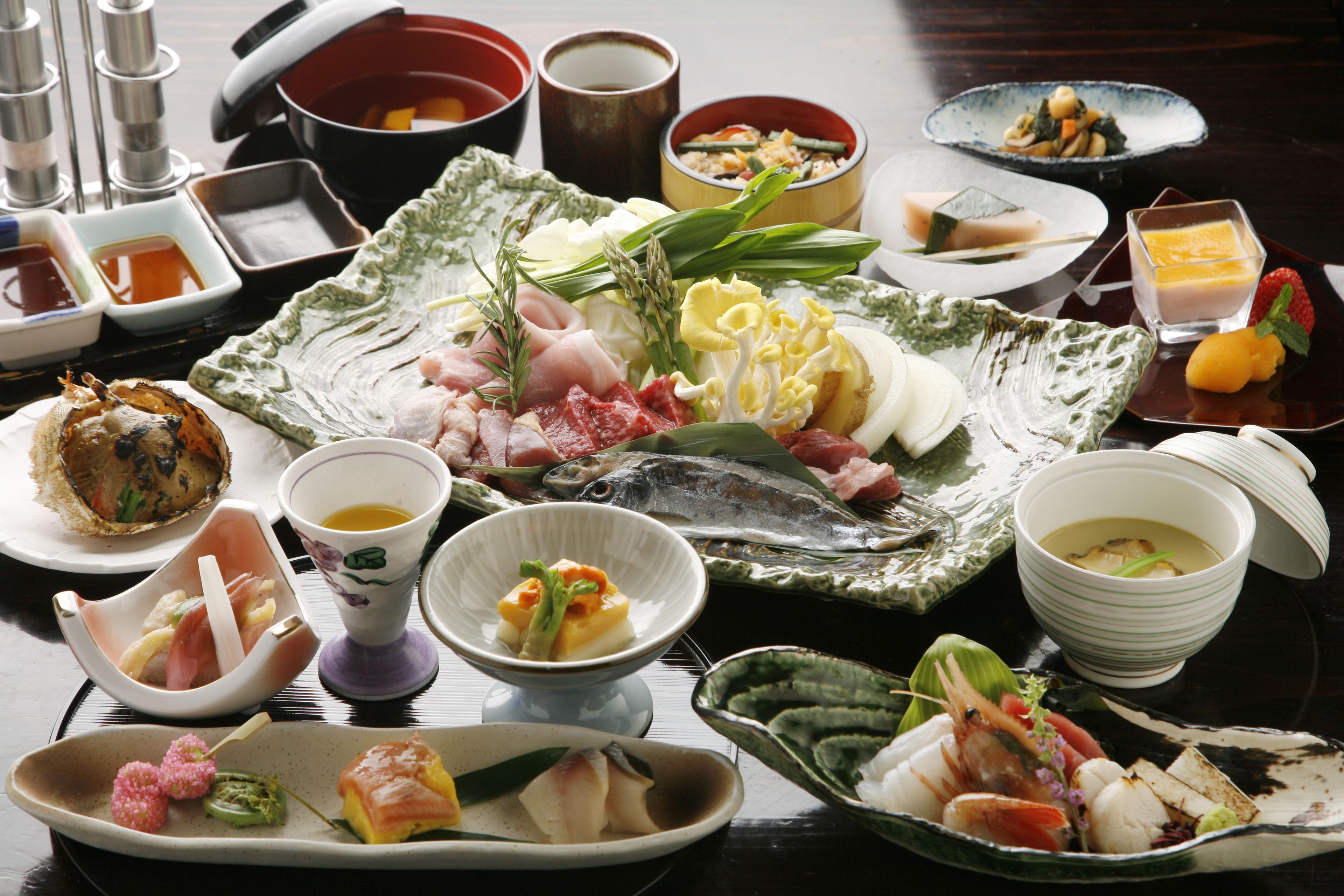 A variety of dishes and bowls on a table, likely for a meal.