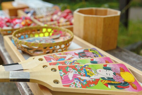 A wooden tray with colorful illustrations and a wooden cup.