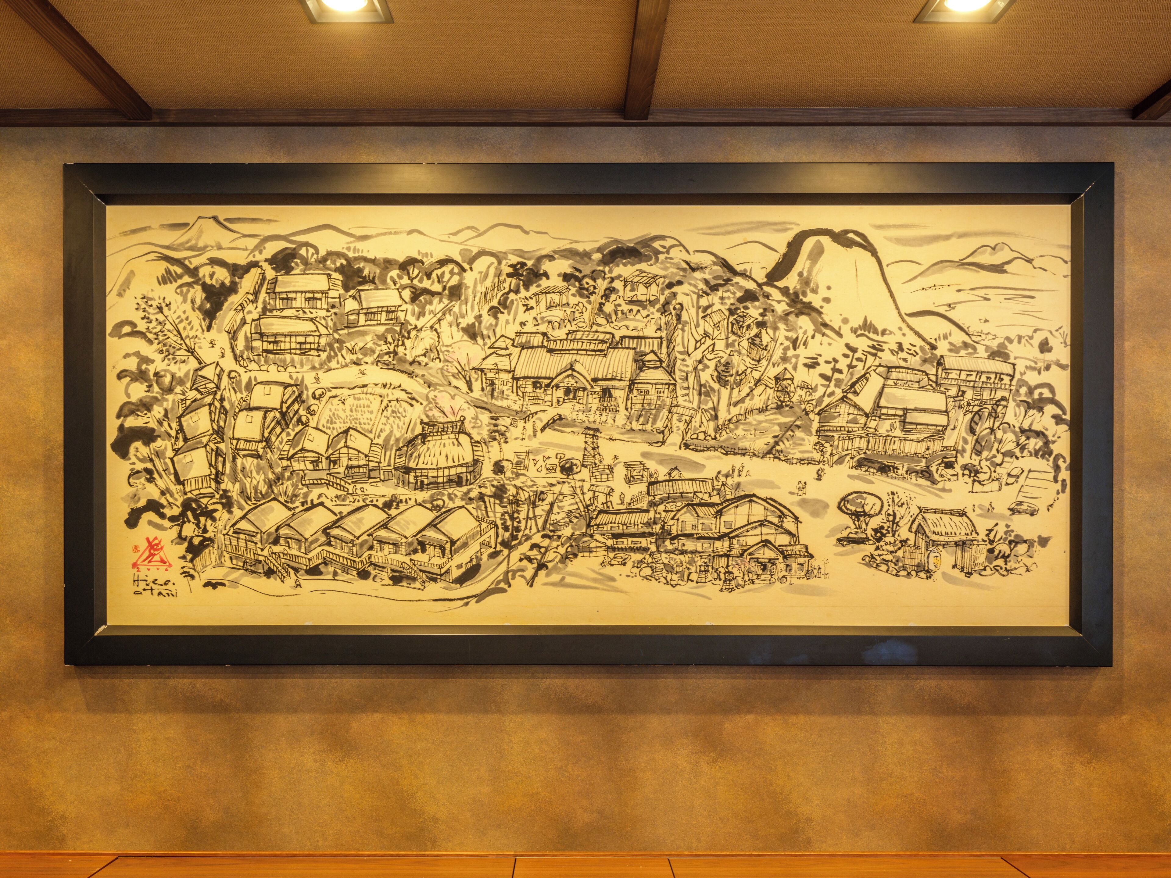 A framed traditional Japanese ink painting depicting a mountainous village scene.