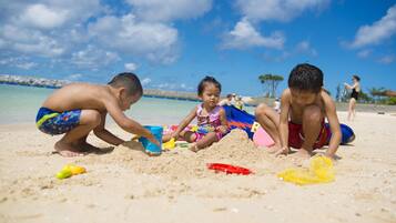 Guests can enjoy a safe beach experience with a lifeguard station nearby and a calm ocean view.