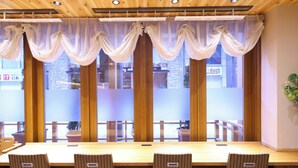 A conference room with a long wooden table and four striped chairs. - Dormy Inn Sapporo Annex Hot Spring (Sapporo)