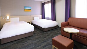 A hotel room with two beds, a sofa, a small table, and a painting on the wall. - Dormy Inn Sapporo Annex Hot Spring (Sapporo)
