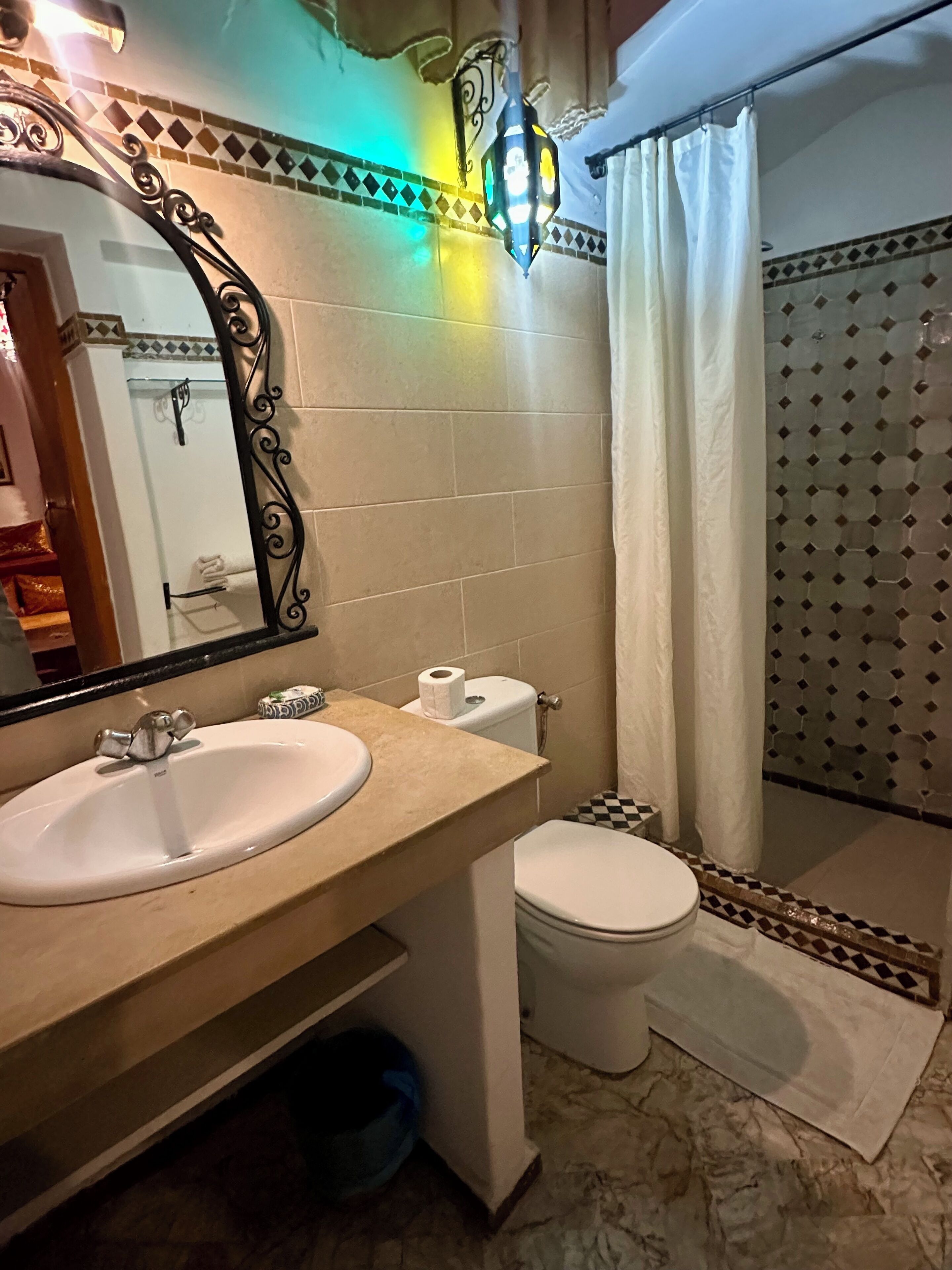 A bathroom with a sink, toilet, and shower.