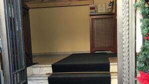 A staircase with black carpeted steps leading to a door. - Villa Margherita (Naples)